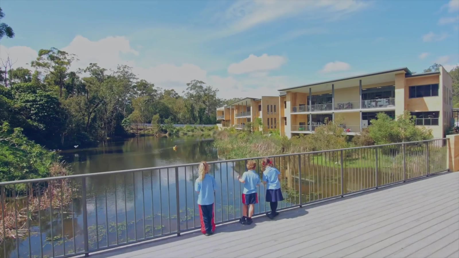 Students on the bridge over the lake at Hillcrest Christian College